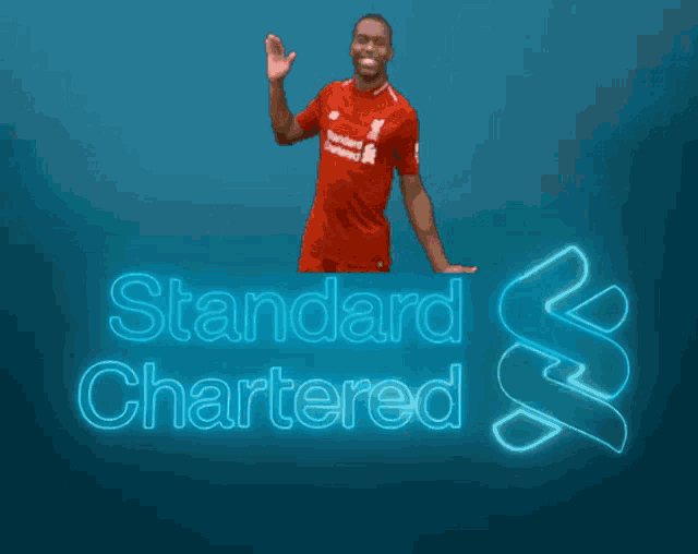 a man in a red shirt with the word standard on it