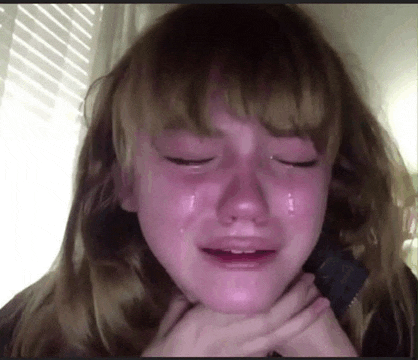 a girl is crying with tears coming down her face