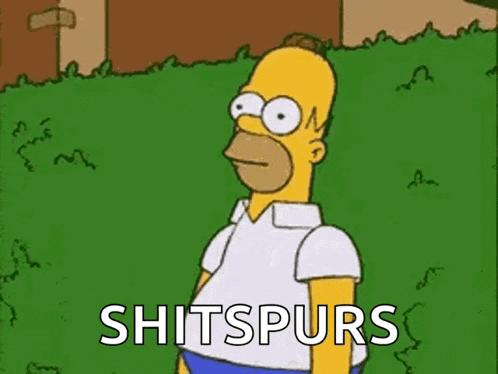 homer simpson from the simpsons is standing in the grass with the words shitspurs written on the grass .