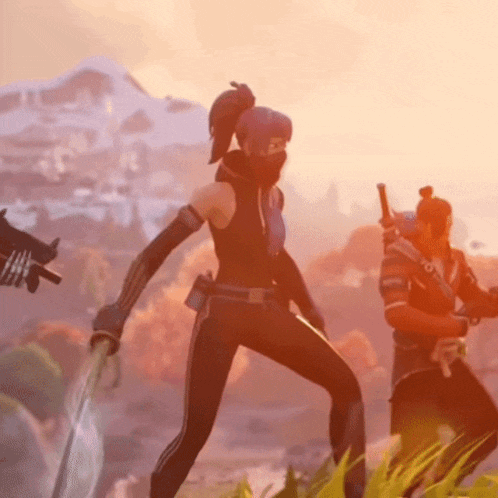 a woman in a mask is standing in a field with a man holding a gun