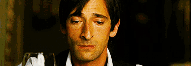 a close up of a man 's face with a sad look on his face .