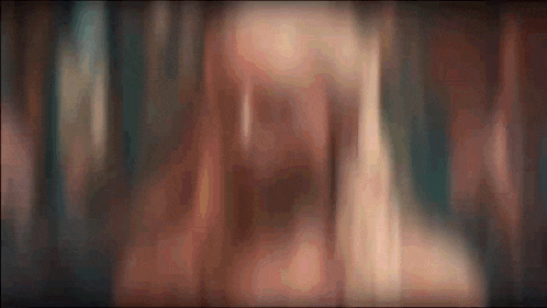 a blurry picture of a person 's face with a blurred background