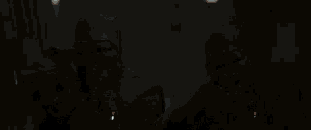 a close up of a person holding a light saber in the dark .