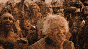 a group of people are standing in a crowd and one of them has a beard