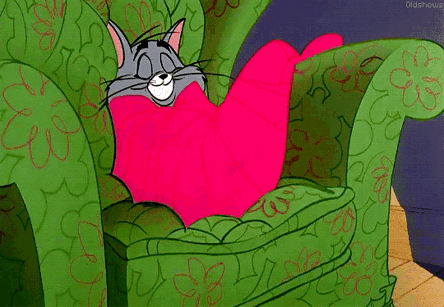a cartoon cat is sitting in a green chair