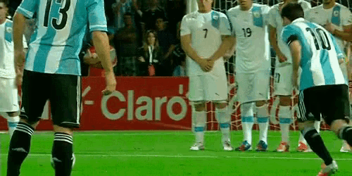 a group of soccer players on a field with a claro sign in the background