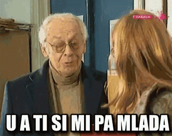 an older man and a younger woman are talking to each other with the words u a ti si mi pa mlada