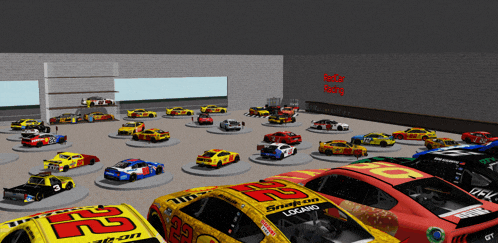 a bunch of race cars are on display in a garage