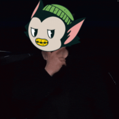 a person wearing a cartoon mask with a green hat