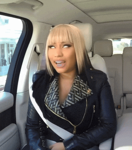a woman in a leather jacket is sitting in the back of a car