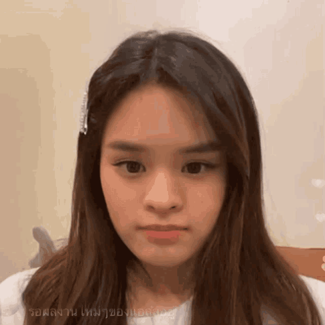 a close up of a woman 's face with a foreign language written in the corner