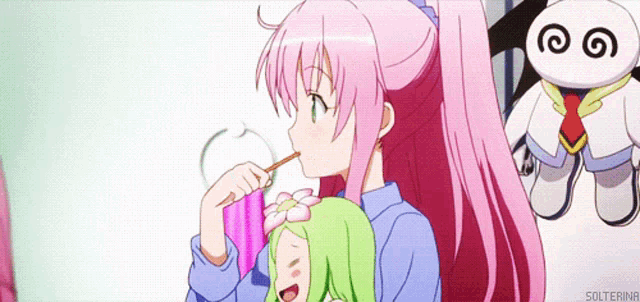 a girl with pink hair is drinking from a pink cup with a straw