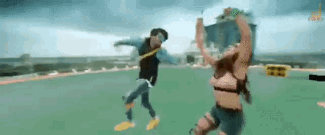 a man and a woman are dancing on a rooftop in a video game .