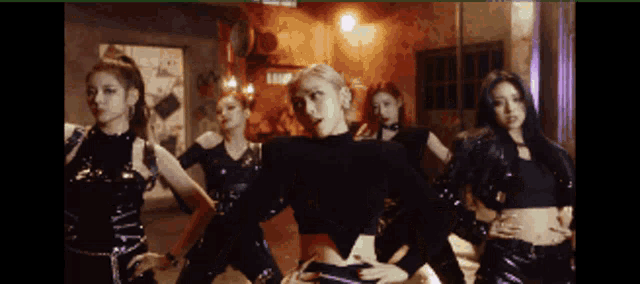 a group of women are dancing in a room with a sign that says ' a ' on it