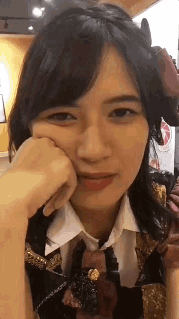 a close up of a woman making a funny face with her hand on her face .