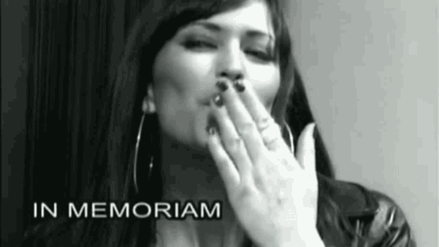 a black and white photo of a woman blowing a kiss with the words in memoriam written below her