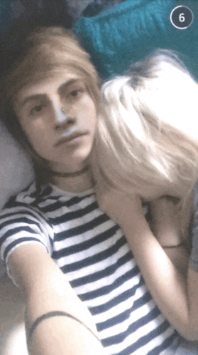 a man and a woman are kissing with the number 6 on the bottom right