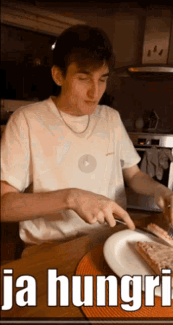 a man in a white shirt is cutting a piece of pizza on a plate with the words ja hungri written below him