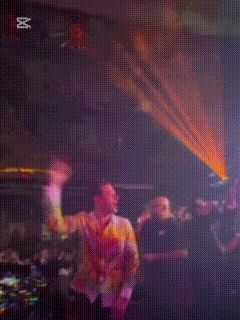 a blurry picture of a man dancing in a dark room with the word cut in the upper right corner