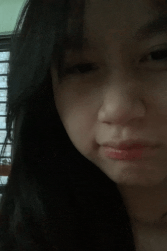 a close up of a woman 's face with a slight smile on her face
