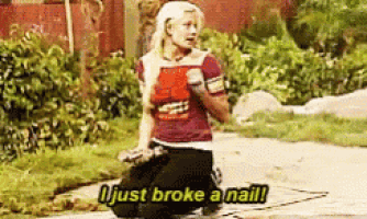 a woman is kneeling down on the side of the road and saying i just broke a nail .
