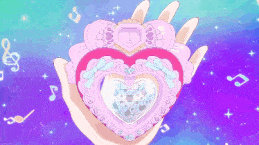 a hand is holding a pink heart shaped item with a diamond inside