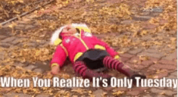 a doll is laying on the ground with the words `` when you realize it 's only tuesday '' written above it .