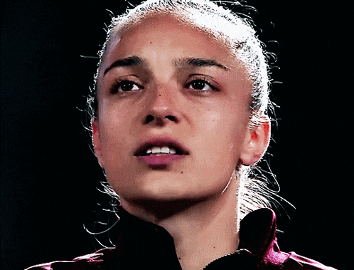 a close up of a woman 's face with a ponytail