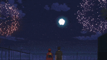 a man in a red hat is watching fireworks