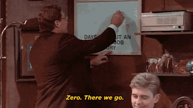 a man in a suit is pointing at a white board that says " days out an job "