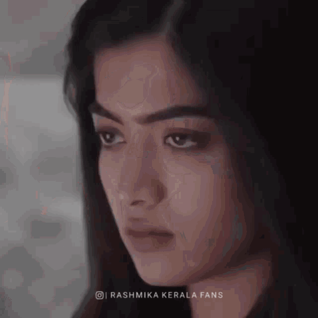 a close up of a woman 's face with the words rashmika kerala fans below her