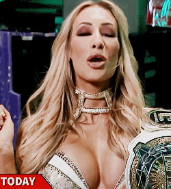 a woman in a very revealing outfit is holding a championship belt with the word today on it