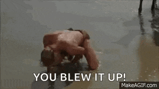 a man is laying on the beach with the words `` you blew it up '' written above him .