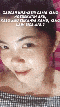 a close up of a woman 's face with a pink background