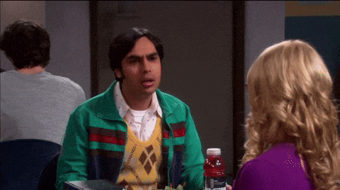 a man in a green jacket talking to a woman