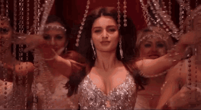 a woman is dancing in front of a group of women