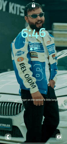 a man standing next to a car with the time of 6:46 on the screen