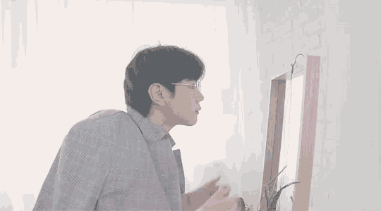 a man is looking at himself in a mirror .