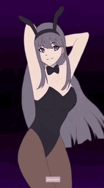 a girl in a bunny suit is dancing with her hands in the air .