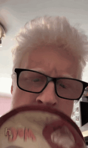 a close up of a person wearing glasses and a hat that says dyslexia on it
