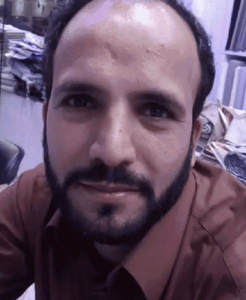 a man with a beard and a bald head is smiling for the camera