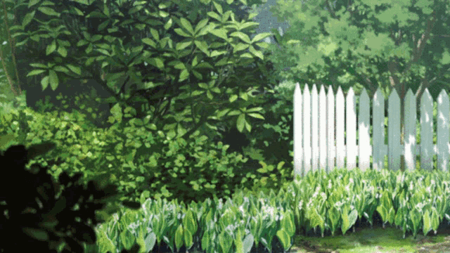 a white picket fence surrounds a lush green field