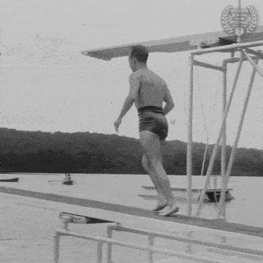 a black and white photo of a man on a dock with a atlanta international film festival laurel on the bottom