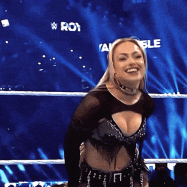 a woman in a wrestling ring with a sign that says w roy on it