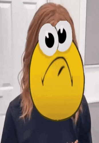 a woman is wearing a cartoon smiley face on her head .