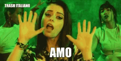 a woman is making a funny face with the word amo on her face
