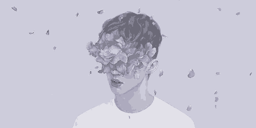 a man with purple flowers on his face is surrounded by purple petals .