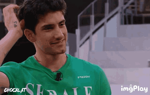 a man in a green shirt with the word freddy on the front
