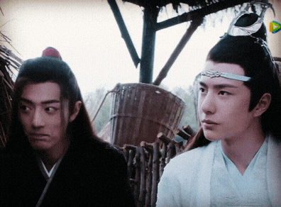 two men are standing next to each other and one is wearing a crown