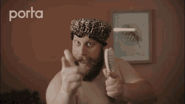 a man with a beard wearing a leopard print shower cap with the word porta behind him